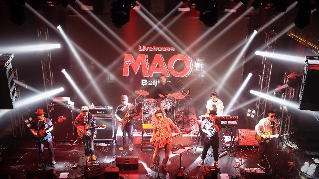 Band stage lighting setup with moving head lights, LED par lights, DMX controller and truss structure for live event performance system