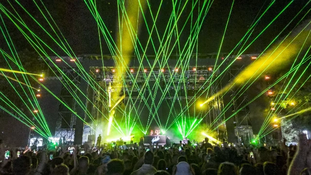 Laser stage lighting system with DMX controller, beam scanning effects integrated with moving head lights on truss structure in professional setup