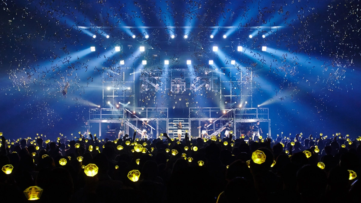Beam moving head lights creating narrow aerial effects above a professional concert stage