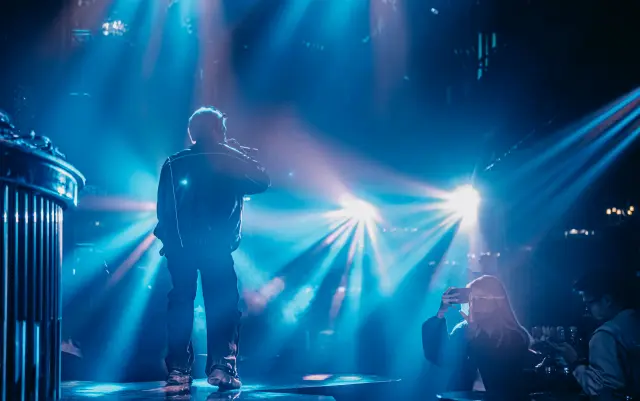 how to use concert laser lights in stage show design showing concert laser beams stage geometry haze audience atmosphere and integrated concert lighting scene design